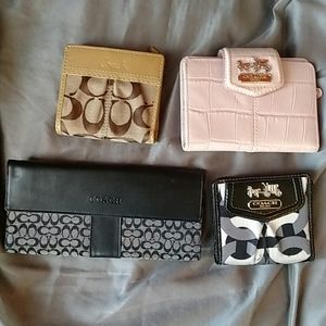 Bundle of 4 coach wallets.